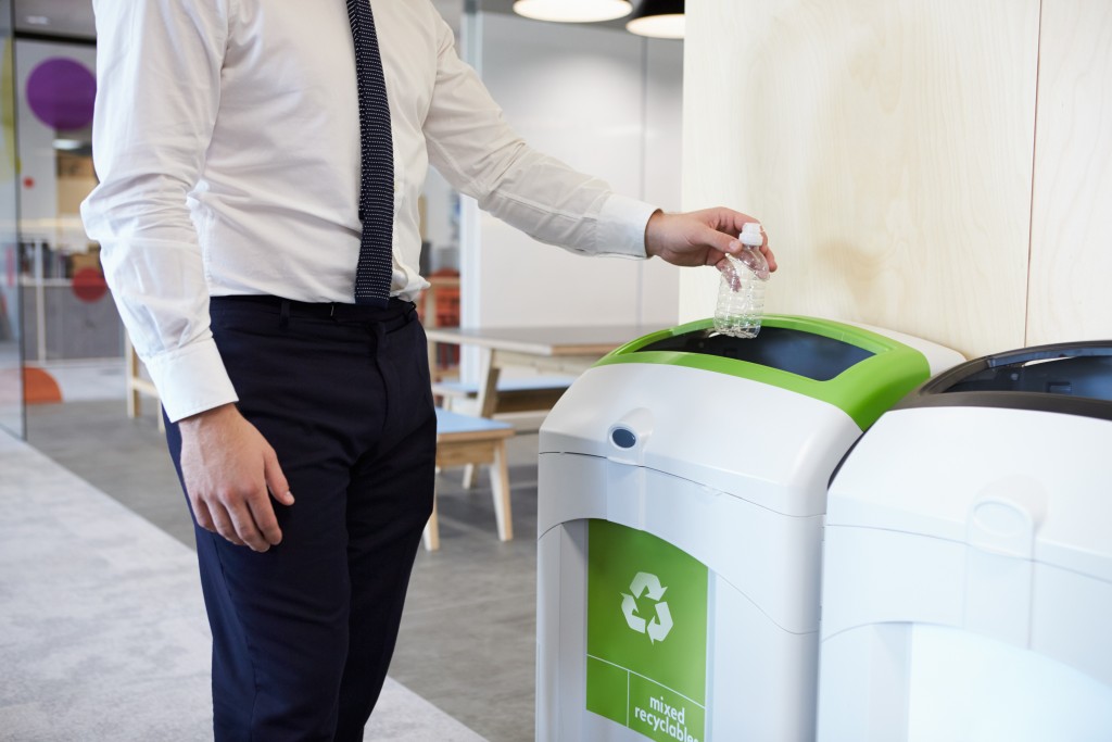 throwing plastic bottle at the recycle bin