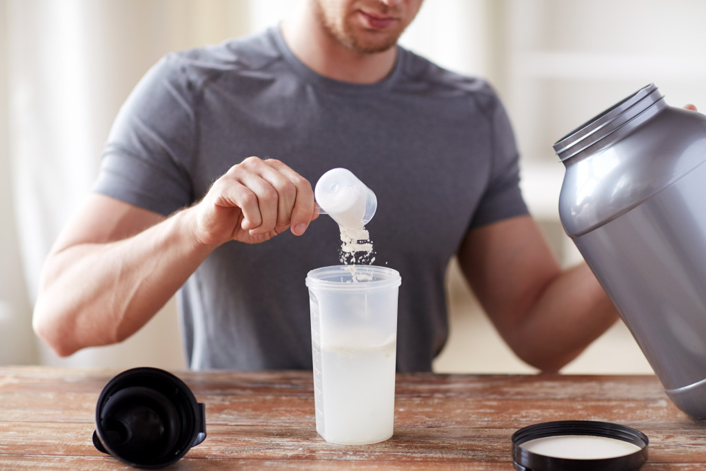 man making a protein shake