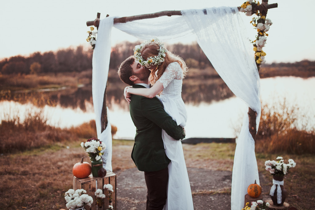 newlyweds kissing on a barn wedding