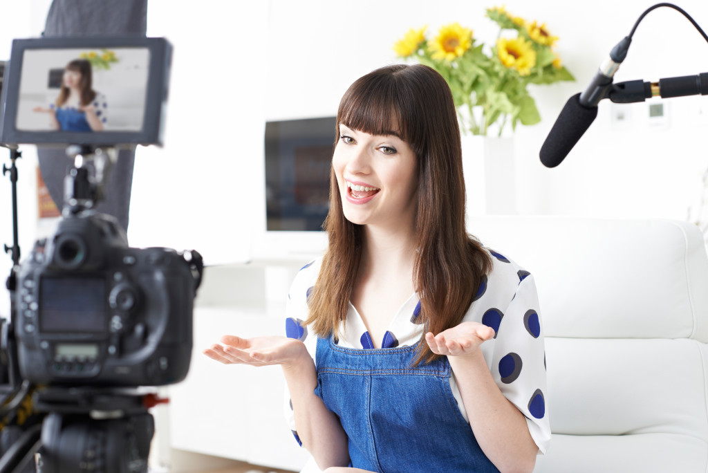 Young female celebrity recording a video at a studio.